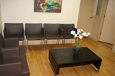 The image shows a waiting area with multiple chairs arranged around a central table, providing seating for visitors.